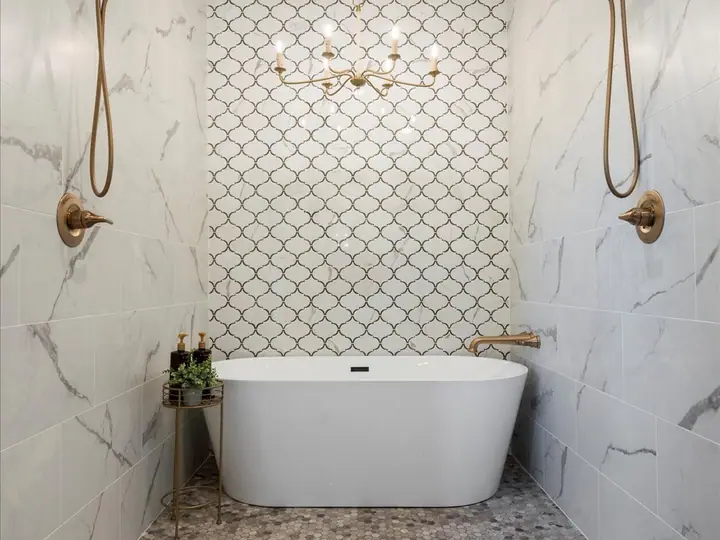 Custom walk-in shower and freestanding tub with brass fixtures