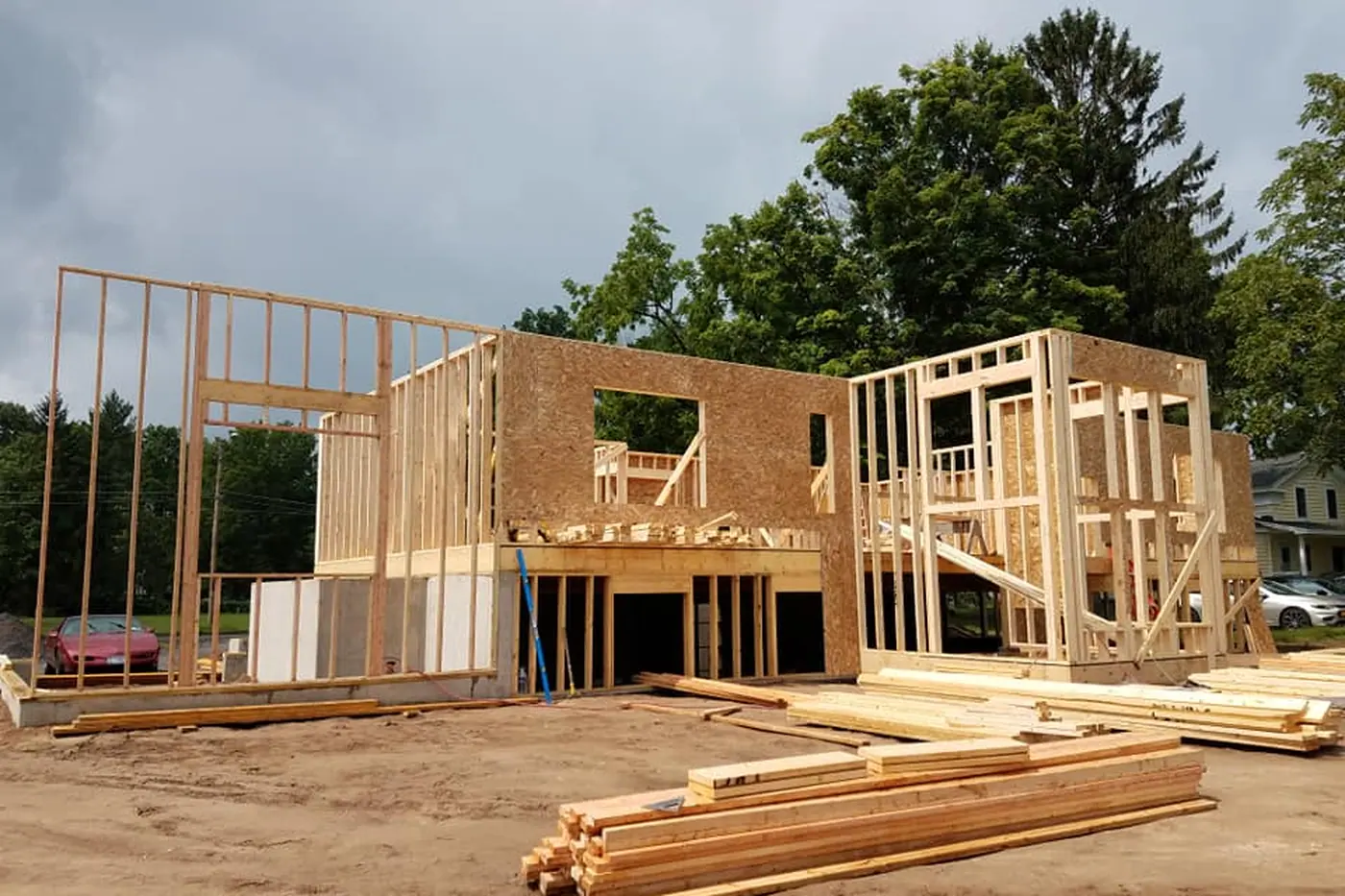 A two-story frame standing, with sheathing under way