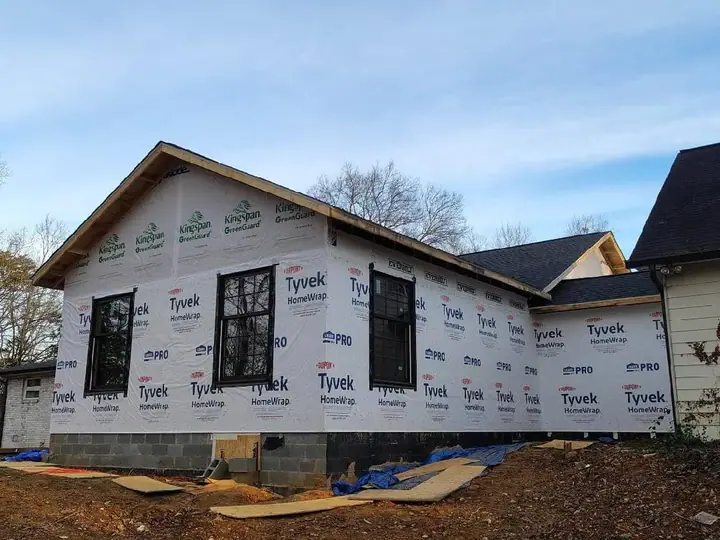 New addition wrapped and windowed, tying into the existing roofline