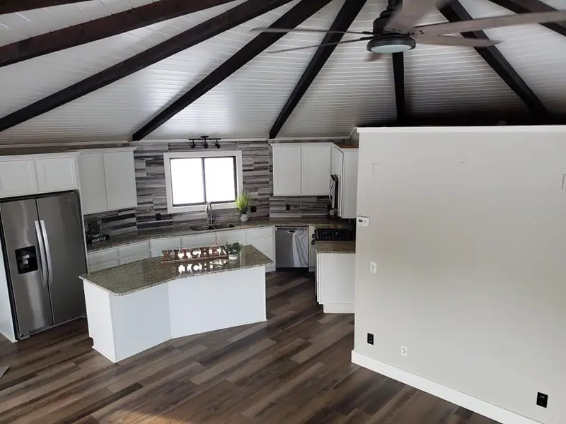 White kitchen under exposed darkened beams