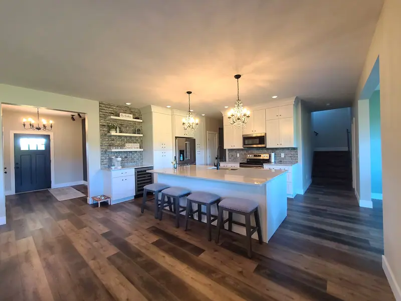 Open kitchen with a long island and seating for five