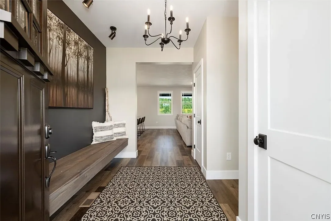 Entry hall with built-in storage and a wood bench in Central Square, NY.
