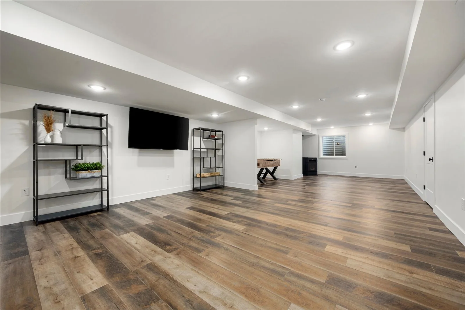 Finished lower level with open living space and recessed lighting in Central Square, NY.