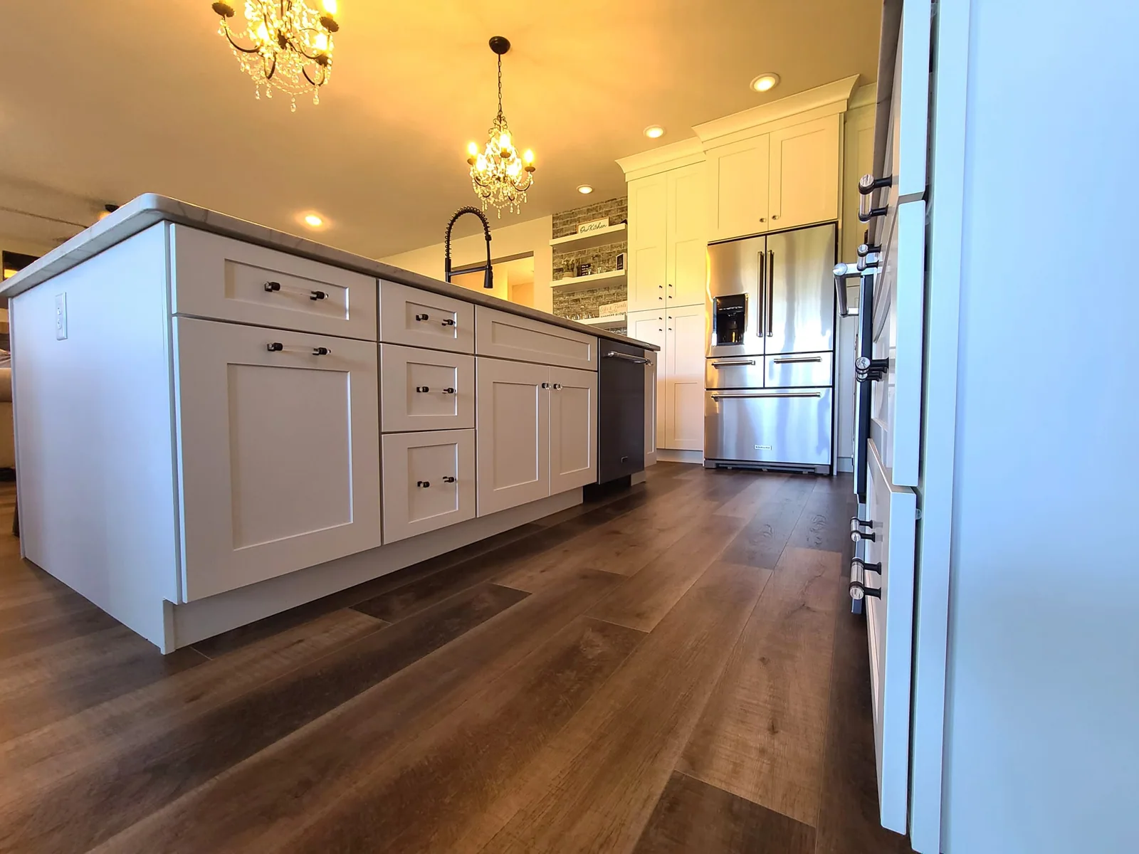 Kitchen island cabinetry viewed from the wood floor in Central Square, NY.
