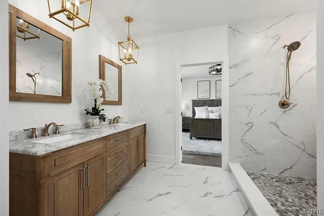 Wood double vanity with suspended mirrors and pendant lights in Central Square, NY.