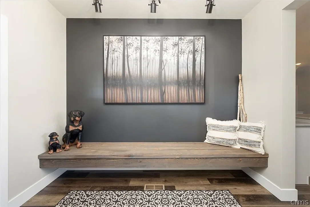Floating wood bench in the entry alcove in Central Square, NY.