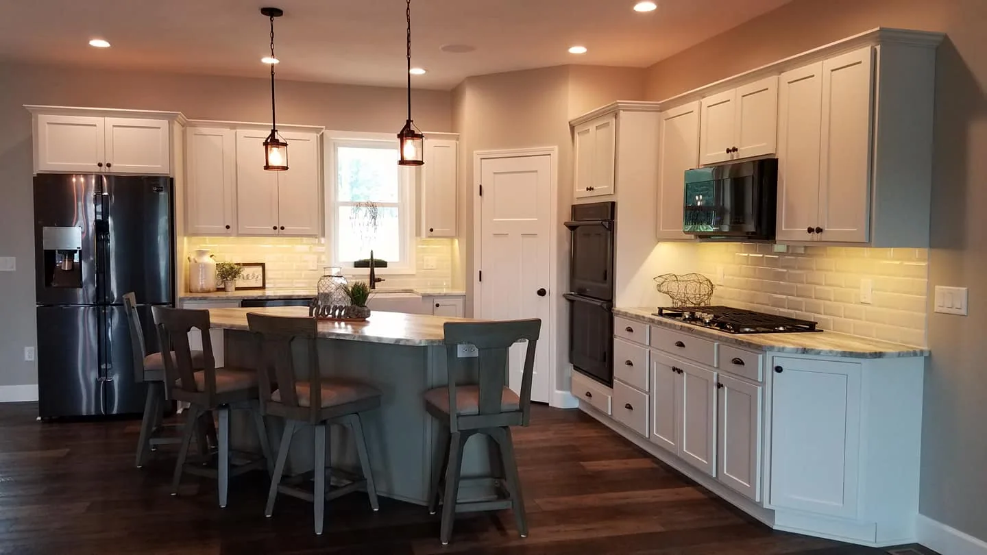 Kitchen island, wood cabinetry, and pendant lighting in Hastings, NY.